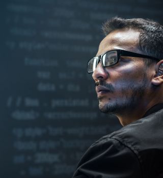 Man analysing binary code on virtual screen